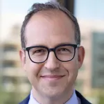Headshot photo of a smiling white male faculty member with glasses, Dr. Yair Blumenfeld, Professor of OBGYN at Stanford University.