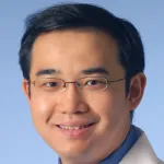 Headshot photo of smiling Asian male faculty member, Dr. Yang Sun, Professor of Ophthalmology at Stanford University.