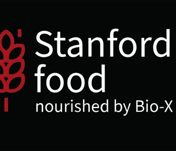 Banner reading "Stanford food - nourished by Bio-X" in white text on black with a red graphic depiction of a sheaf of wheat.