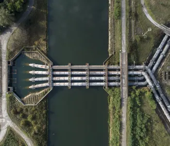 Overhead photograph of a water treatment plant with large intersecting pipes.