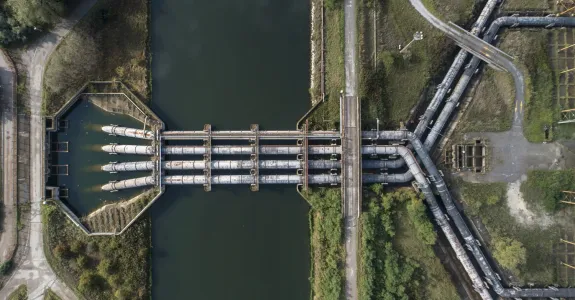 Overhead photograph of a water treatment plant with large intersecting pipes.
