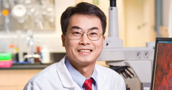 Photo of Dr. Joseph Wu, wearing white coat in laboratory space.