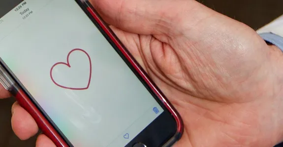 Photo of doctor holding a smartphone.