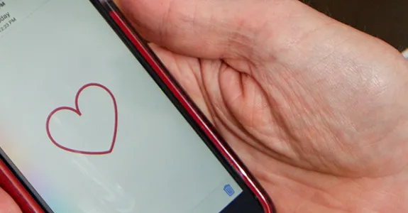 Photo of MyHeart Counts app on phone screen.