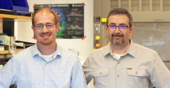 Photo of Drs. Aaron Newman and Ash Alizadeh standing in a laboratory space.