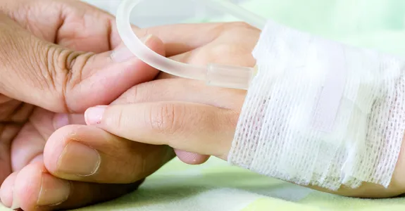 Photo of hand of child in hospital.
