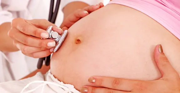 Image of a pregnant woman and a doctor.