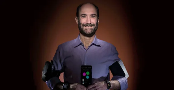 Photo of Dr. Michael Snyder using several wearable devices at once.
