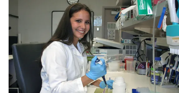 Photo of graduate student Teresa Purzner using a pipette.