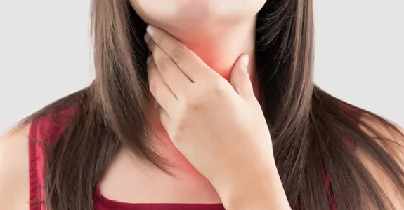 Photo of a woman holding a hand to her throat, with throat lit up in red to indicate pain.