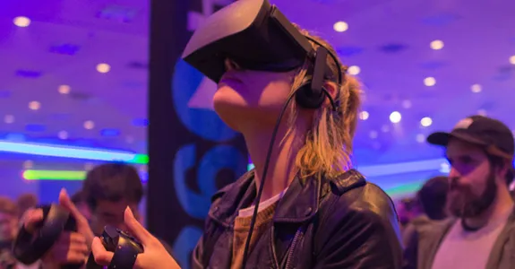 Photo of woman testing virtual reality headset.