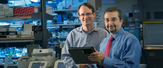 Photo of Ash Alizadeh and Maximilian Diehn in the lab.