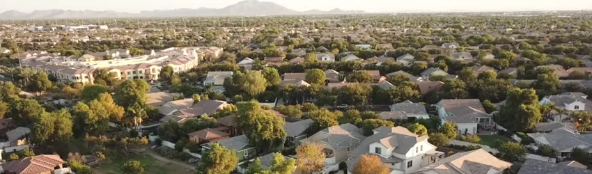 Overhead view of numerous "cookie-cutter" style houses' roofs.