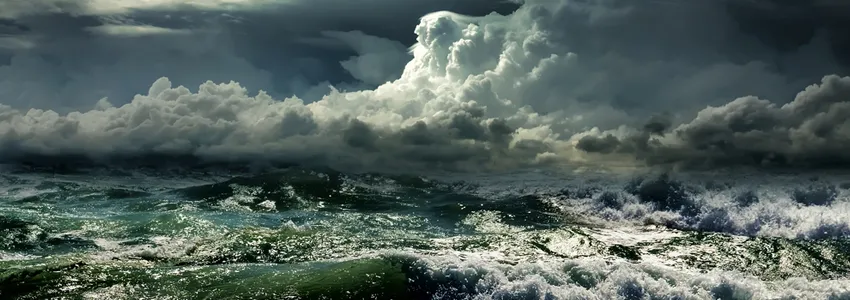 Photo of stormy seascape with strong waves and clouds.