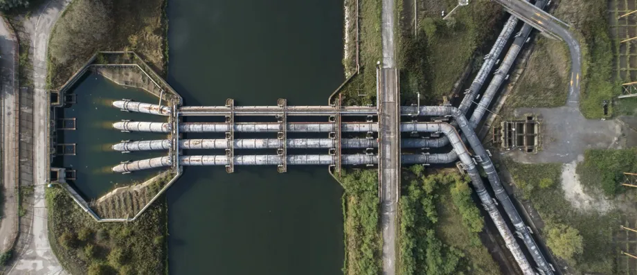 Overhead photograph of a water treatment plant with large intersecting pipes.