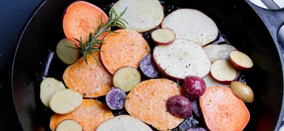 Photo of colorful potatoes being cooked in a pan.