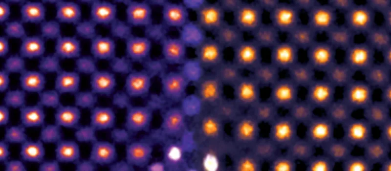 Colorized transmission electron microscopy of ceria ultrathin film, showing atoms as yellow and orange dots against purple.