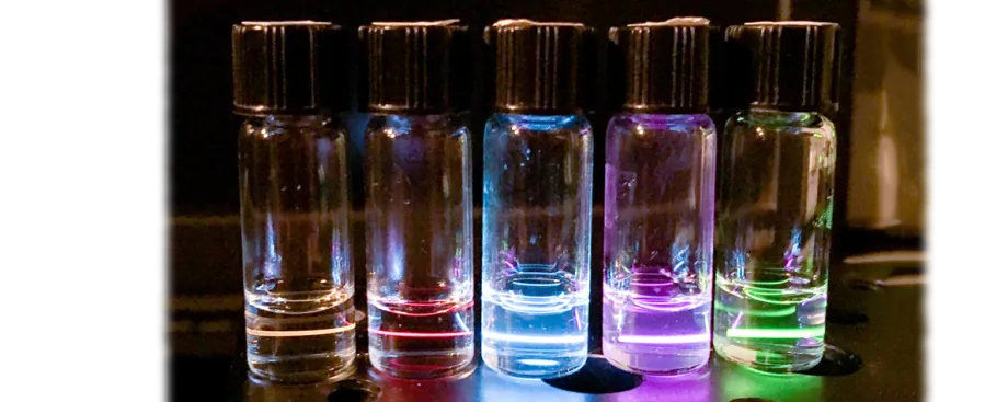 Photo of tubes emitting different colors of light.