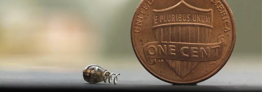 Photo of Dr. Poon's electronic device next to a penny.