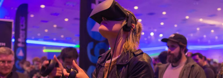 Photo of woman testing virtual reality headset.