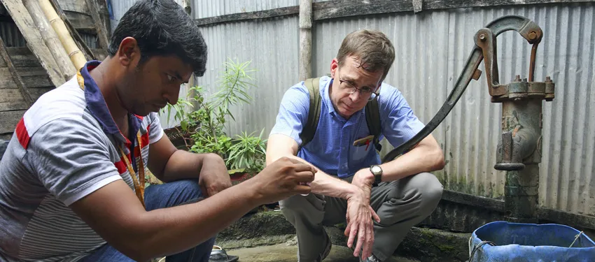 Photo of Dr. Stephen Luby with a teammate in Dhaka, Bangladesh, testing water samples.