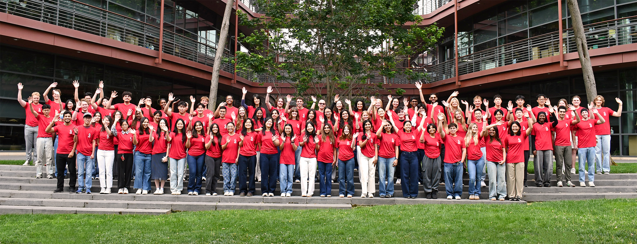 86 undergraduate students outdoors, wearing matching red T-shirts with white Bio-X logo.