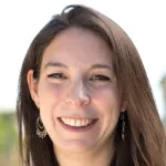 Photo of smiling white female faculty member with long brown hair, Dr. Andrea Goldstein-Piekarski, Assistant Professor of Psychiatry & Behavioral Sciences at Stanford University.